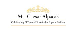 Mt. Caesar Alpacas logo with a gold decorative flourish and the tagline 'Celebrating 21 Years of Sustainable Alpaca Fashion' beneath the brand name.